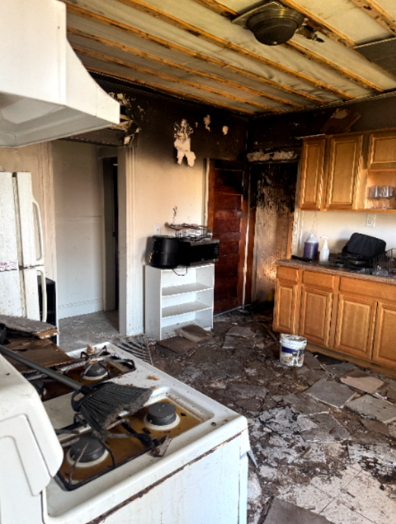 Kitchen with fire damage before debris removal